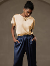 [Champagne] Model wearing champagne silk short sleeve boat neck top with navy silk pants 010