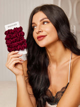 [Fuchsia] Woman holding burgundy 100% mulberry silk hair scrunchies on SilkSilky card 001