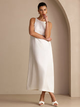[White] white sleeveless scoop-neck midi dress, gathered waist and side pockets, full front view, arms crossed. 006