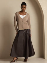 [Tan] Complete frontal view: beige cardigan, white camisole, and dark brown maxi skirt, showing the overall cut and hem. 006