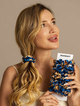 [Navy Dragon] Woman holding blue patterned silk hair scrunchies from SilkSilky 005