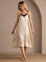 Ivory V-neck nightgown with black trim in a full front view, arms down and ankles crossed.