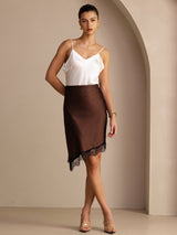 [Coffee] Coffee brown asymmetrical lace-hem skirt in a full front view with one hand at her hip. 005