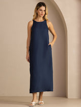 [Dark Blue] navy blue sleeveless scoop-neck midi dress, gathered waist and side pockets, full front view, one arm extended. 005