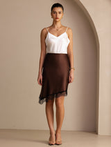[Coffee] Coffee brown asymmetrical lace-hem skirt on a model in a full-body front view with one foot forward and arms relaxed. 006