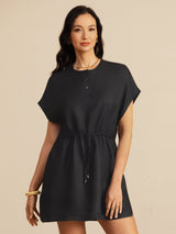 [Black] black cap-sleeve short dress with drawstring waist and pockets, waist-up view, model standing with both arms relaxed. 003