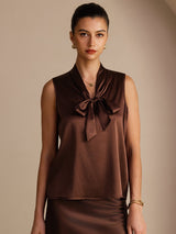 [Bitter Chocolate] Dark brown sleeveless tie-neck top on a model in a mid-length front view with arms relaxed and shoulders square. 001