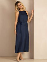 [Dark Blue] Full-length side view of a silk midi dress with scoop neck, gathered waist, and side pockets in navy blue 004