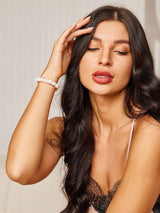 [Black] Woman wearing black silk hair scrunchie on wrist, long dark hair, 100% mulberry silk 003