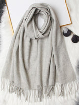 [Light Gray] light gray rectangular shawl with fringed edges, flat lay, folded in soft layers with the fringe visible. 005