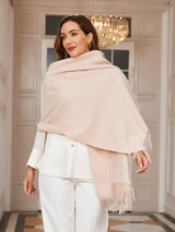[Beige] very pale pink rectangular shawl with fringed edges, styled front view, draped broadly around the shoulders. 002