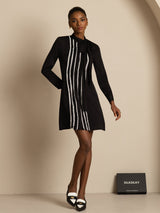 [Black] Head-to-toe front view: black long-sleeve tunic mini dress with vertical white stripes, showing the full silhouette. 005