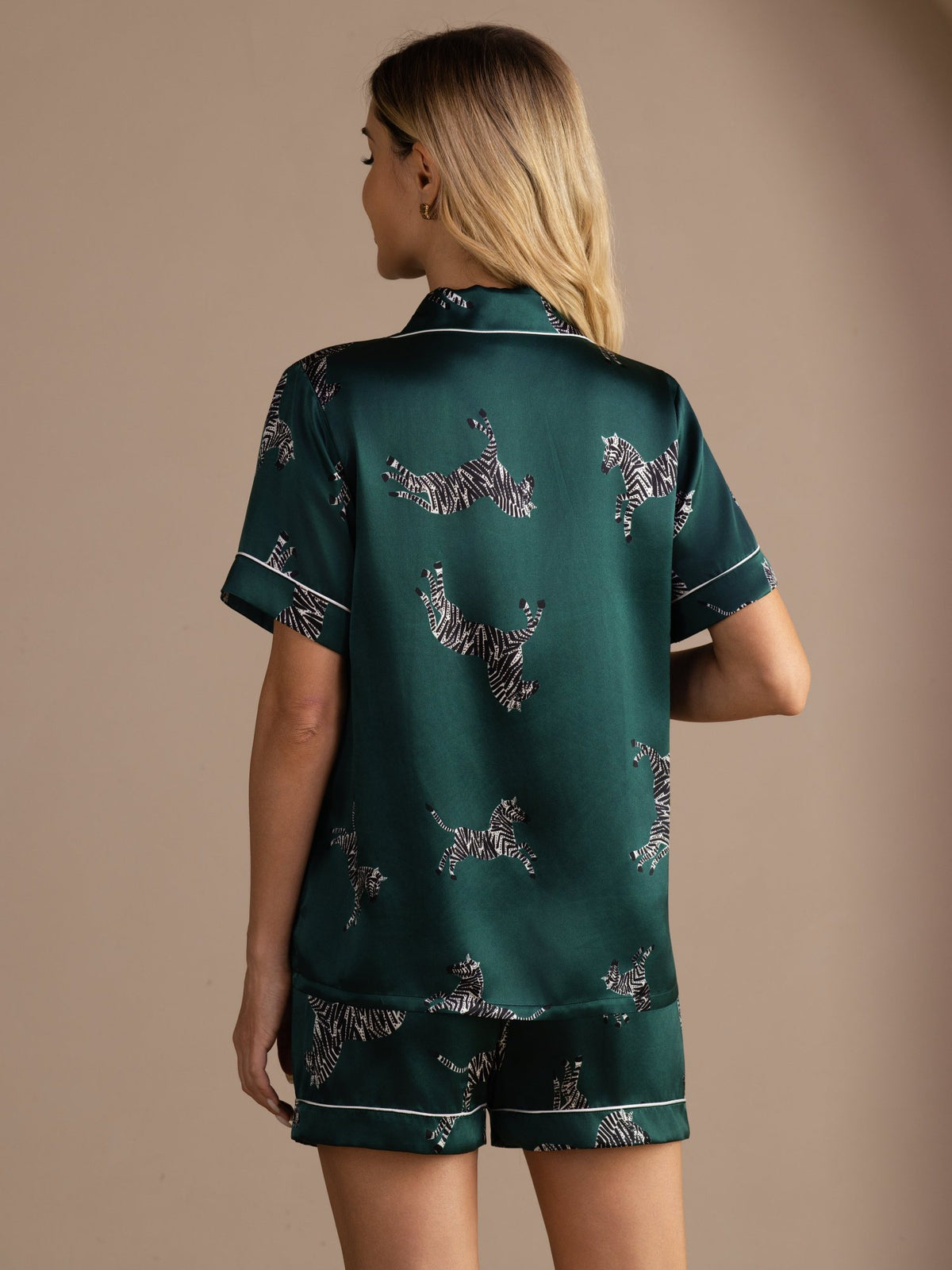 [Emerald Zebra] Full back view of a silk short-sleeve pajama set with shorts in emerald green with small light animal motifs 002