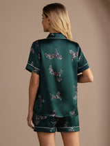 [Emerald Zebra] Full back view of a silk short-sleeve pajama set with shorts in emerald green with small light animal motifs 002