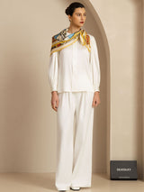 [P107] The side profile of multicolor print scarf with a gold border becomes visible as the model holds a three-quarter pose. 005