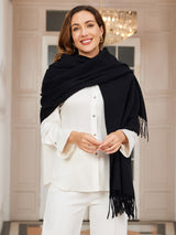 [Black] black rectangular shawl with fringed edges, styled front view, wrapped at the neck with fringed ends down the front. 003