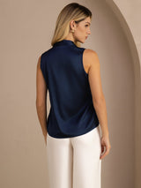 [Dark Blue] Mid-length back studio view of a model wearing navy blue sleeveless tie-neck blouse. 002