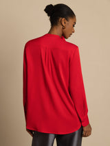 [Wine] Rear studio view of a model wearing a red long-sleeve collared blouse with gray wide-leg trousers. 002