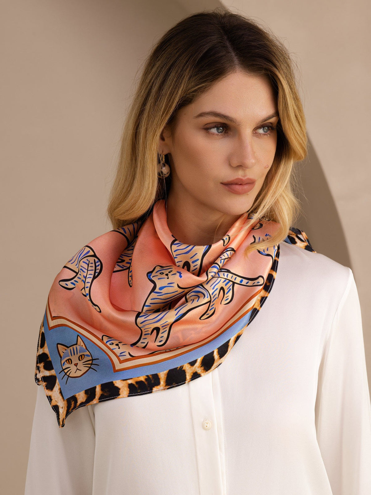 [Pink Cat] Coral pink animal-print square scarf with blue-and-black patterned border, styled front, diagonal shoulder drape. 002