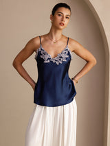 [Dark Blue] Angled front view of a navy blue silk camisole with spaghetti straps and pale floral lace at the V neckline 003