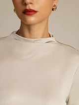 [Gray] Close studio view of a model wearing a light gray short-sleeve crew-neck top with a white skirt. 004