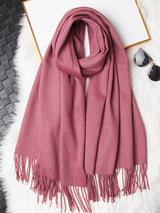 [Pale Mauve] pale mauve rectangular shawl with fringed edges, flat lay, loosely coiled to show the fringe and full color. 006