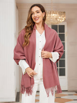 [Pale Mauve] pale mauve rectangular shawl with fringed edges, styled front view, draped over the shoulders with hand holding an edge. 003
