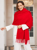 [Red] bright red rectangular shawl with fringed edges, styled front view, draped over the shoulders with hand holding an edge. 002
