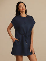 [Dark Blue] navy blue cap-sleeve short dress with drawstring waist and pockets, waist-up view, model with one hand in a pocket. 003