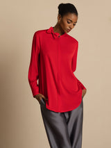[Wine] Red collared blouse with gray wide-leg trousers in a front crop to thighs, both hands in pockets, model looking down. 005