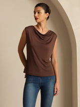 [Coffee] Coffee-brown cowl-neck top with blue jeans in a front crop to thighs, one hand behind the body and the other lowered. 004