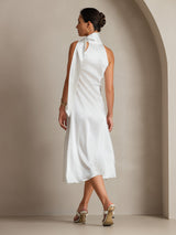[White] Viewed from a three-quarter angle, white scarf-neck maxi dress shows its side silhouette as the model turns. 002