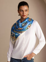 [Blue Fish] Bright blue square scarf with multicolor fish and pale patterned border, styled front, draped at neck, hand in pocket. 005