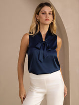 [Dark Blue] Navy blue sleeveless tie-neck top on a model in a mid-length front view with arms relaxed and shoulders square. 005