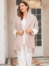 [Light Beige] pale blush pink rectangular shawl with fringed edges, styled front view, over shoulders, hand at edge. 002