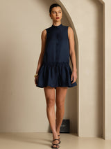 [Dark Blue] Navy sleeveless drop-waist mini dress with gathered ruffle hem in a full front view, with the lower hem visible. 006