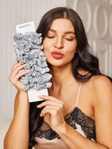 [Light Gray] Model holding a 10-pack of light gray mulberry silk hair scrunchies from SilkSilky 002