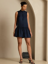 [Dark Blue] Navy sleeveless drop-waist mini dress with gathered ruffle hem in a full-body view, with the legs staggered. 007