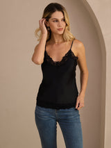 [Black] Black lace-trim V-neck camisole top on a model in a mid-length front view with one hand raised to her hair. 003