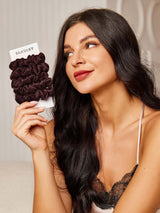 [Brown] Woman holding 5-piece mulberry silk scrunchie set on display card, burgundy satin finish 001