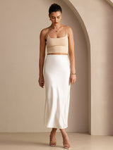 [Ivory] Three-quarter full-body front studio view of a model wearing ivory glossy maxi skirt. 007