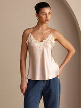 [Pink] Front waist-up view of a pale blush pink silk camisole with spaghetti straps and floral lace at the V neckline 001