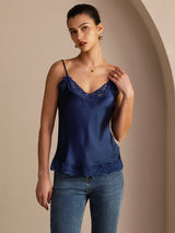 [Dark Blue] Navy blue lace-trim V-neck camisole top on a model in a mid-length front view with one hand lifted near the neckline. 004