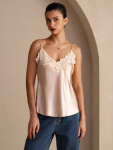 [Pink] Angled front view of a pale blush pink silk camisole with spaghetti straps and floral lace at the V neckline 003