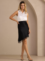 [Black] Black asymmetrical lace-hem skirt on a model in a full-body front view with one hand at her hip and ankles crossed. 008