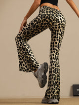 [Leopard] High-rise flared trousers with a black-and-cream leopard print in a waist-up front view, with both arms down. 003