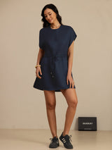 [Dark Blue] navy blue cap-sleeve short dress with drawstring waist and pockets, full front view, model stepping forward. 006