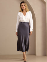 [Dark Gray] Charcoal gray glossy maxi skirt on a model in a full-body three-quarter view with one leg extended to the side. 005