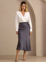 [Dark Gray] Charcoal gray glossy maxi skirt on a model in a full-body front view with one foot forward and arms relaxed. 004