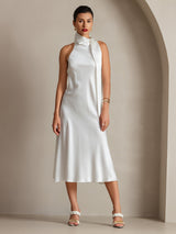 [White] Front full-body framing captures white scarf-neck maxi dress, showing its continuous shape down to the hem. 004
